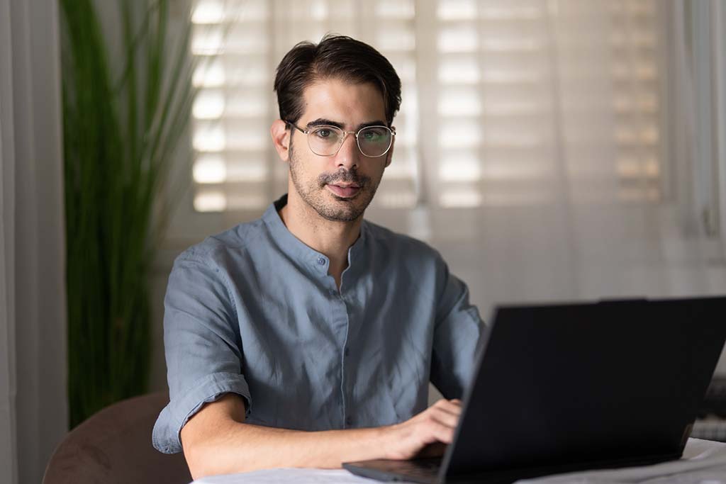 Kfir, the project manager, with a laptop at the table